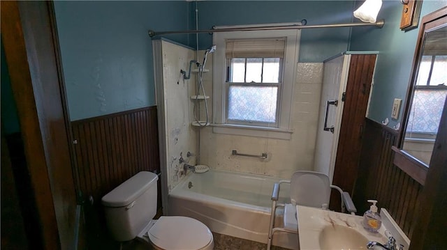 bathroom with toilet and bathing tub / shower combination