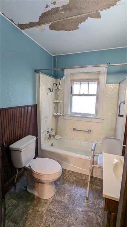 bathroom featuring toilet and tiled shower / bath