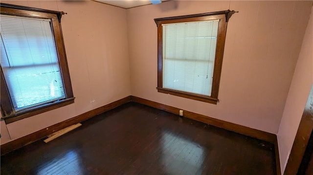 spare room featuring dark wood-type flooring