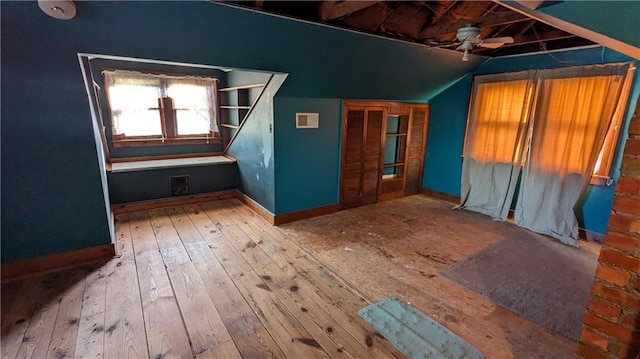 interior space with light wood-type flooring, ceiling fan, and lofted ceiling