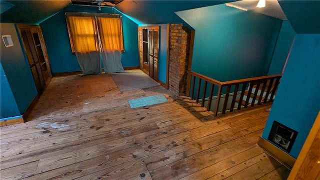 additional living space featuring light hardwood / wood-style flooring and lofted ceiling