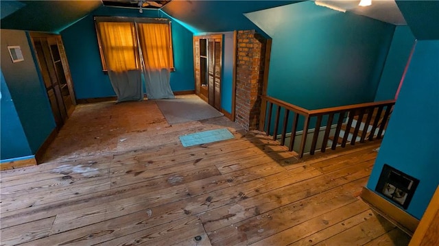 bonus room featuring vaulted ceiling and light hardwood / wood-style flooring