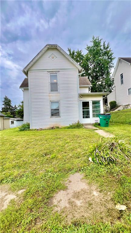 rear view of house with a yard