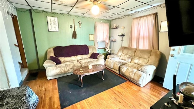 living room featuring wood-type flooring, ceiling fan, and a healthy amount of sunlight