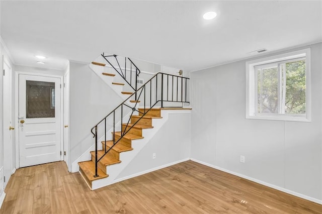 staircase with wood-type flooring