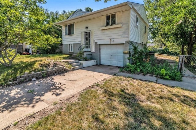 bi-level home with a front lawn and a garage