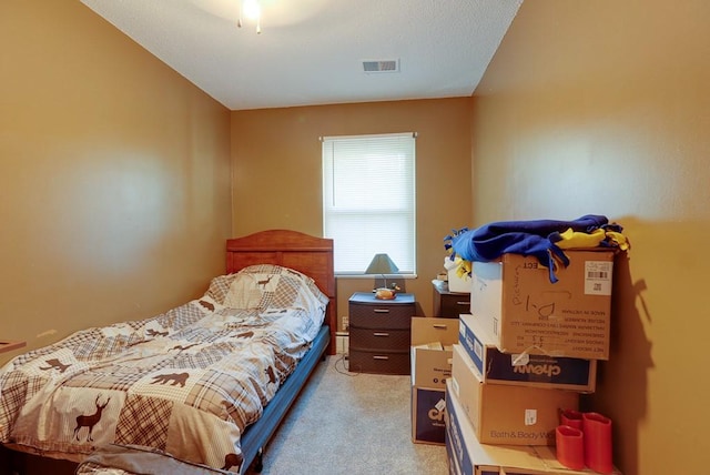 bedroom with light carpet and visible vents