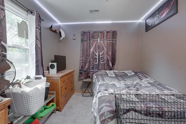 bedroom featuring light carpet and visible vents