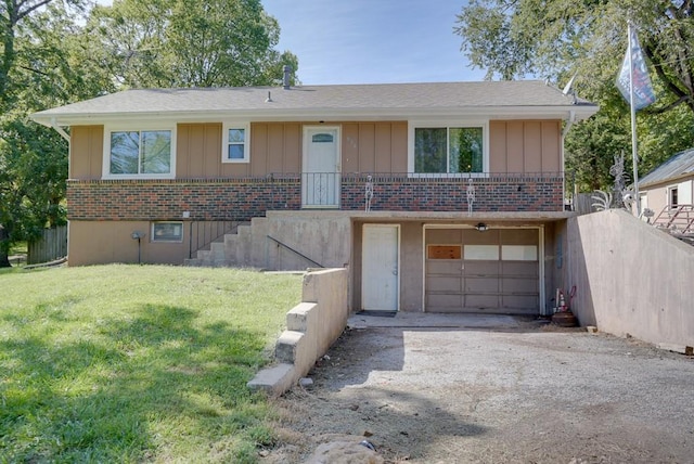 view of front facade featuring a garage, driveway, board and batten siding, and a front yard