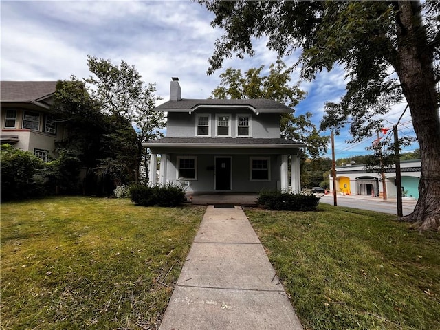 view of front of property featuring a front yard and covered porch