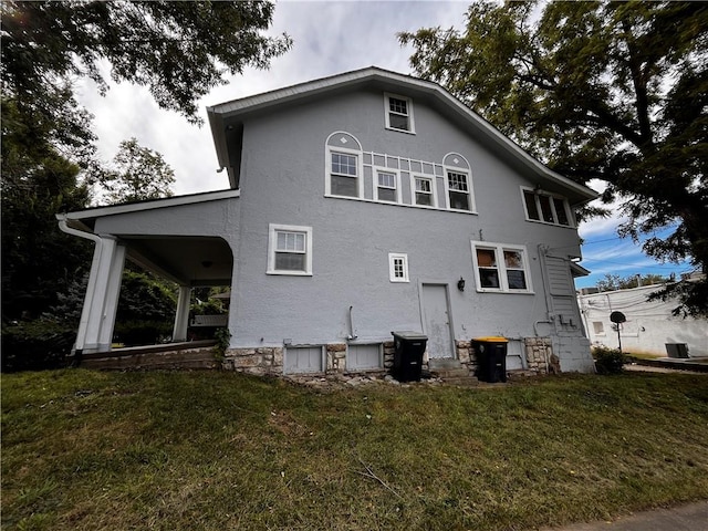 back of house with a lawn