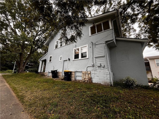 view of property exterior with a lawn