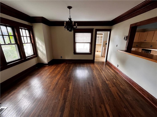 interior space with crown molding, dark hardwood / wood-style floors, and a chandelier