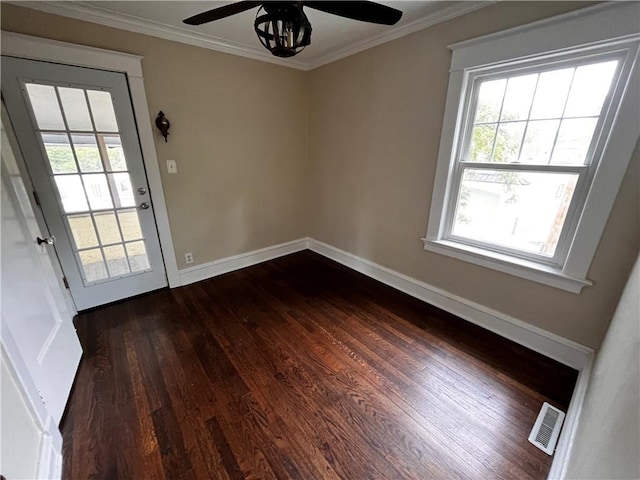 unfurnished room with crown molding, dark hardwood / wood-style flooring, and ceiling fan