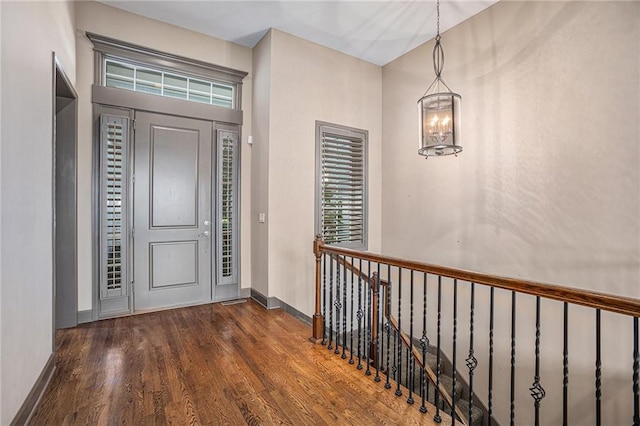 foyer with a notable chandelier and dark hardwood / wood-style floors