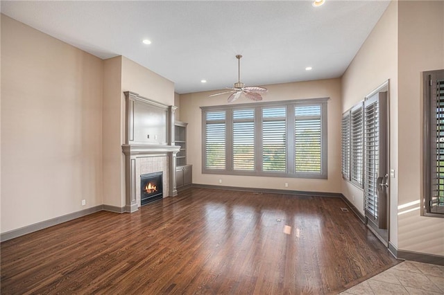 unfurnished living room featuring wood-type flooring and ceiling fan