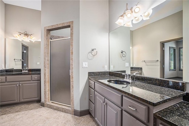 bathroom with tile patterned flooring, vanity, and a shower with shower door