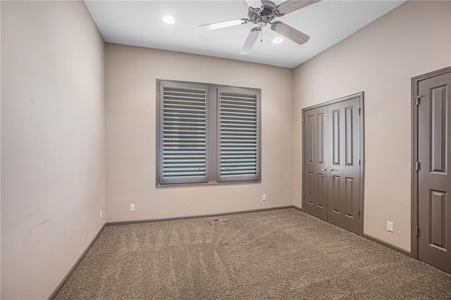 unfurnished bedroom featuring ceiling fan and carpet flooring