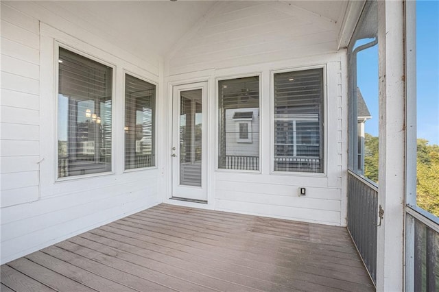 unfurnished sunroom featuring lofted ceiling