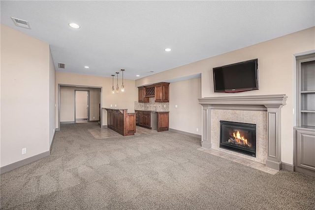 unfurnished living room featuring light colored carpet and a fireplace