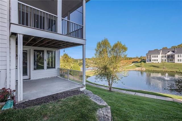 view of yard featuring a water view and a balcony