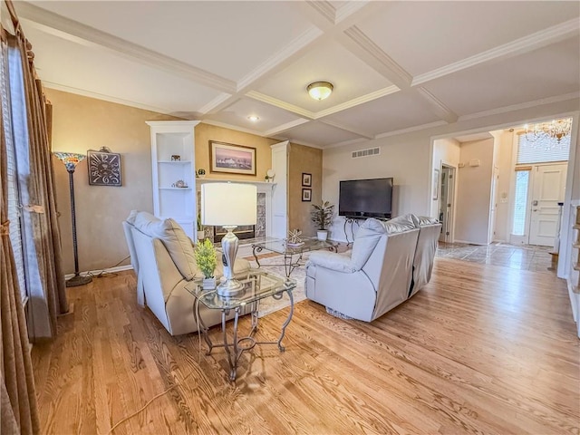 living room with coffered ceiling, beam ceiling, crown molding, and light hardwood / wood-style flooring