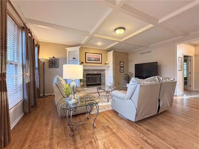 living room with beam ceiling, crown molding, light hardwood / wood-style flooring, and coffered ceiling