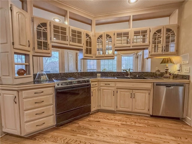 kitchen featuring stainless steel dishwasher, crown molding, sink, black range, and light hardwood / wood-style floors