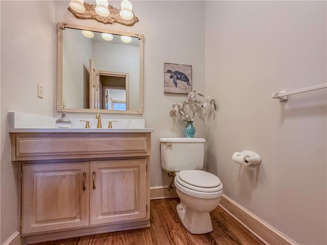 bathroom featuring hardwood / wood-style flooring, vanity, and toilet