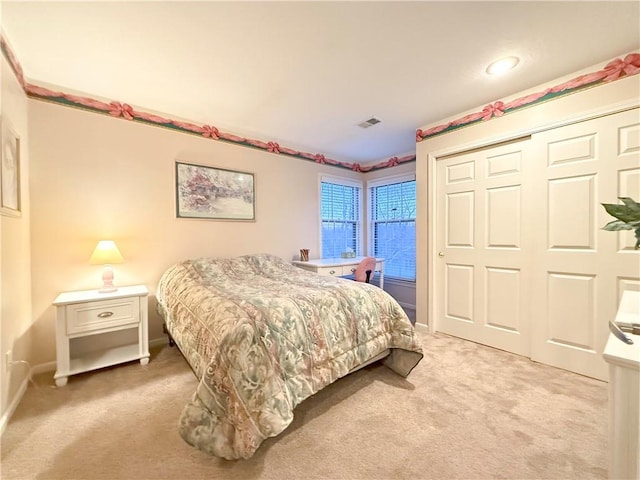 bedroom with carpet and a closet