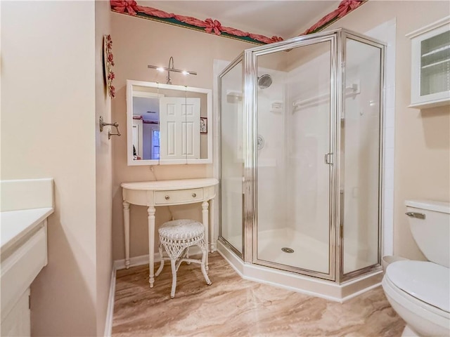 bathroom with toilet and a shower with shower door