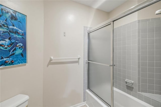 bathroom featuring toilet and enclosed tub / shower combo