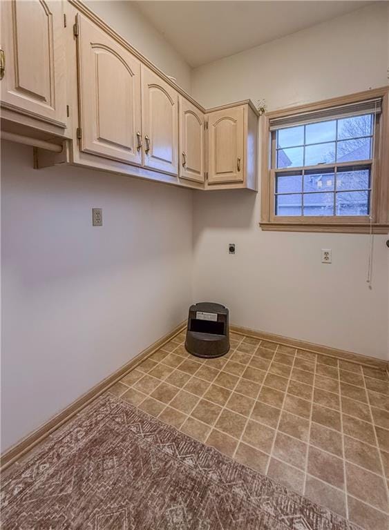 laundry area with tile patterned floors, cabinets, and hookup for an electric dryer