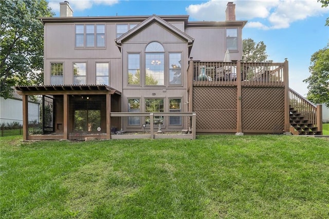 back of property featuring a deck and a yard