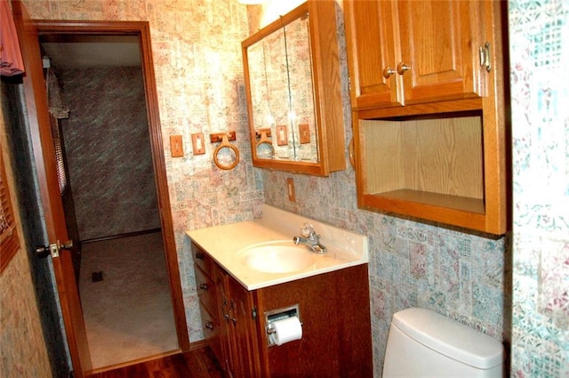 bathroom featuring hardwood / wood-style flooring, vanity, and toilet