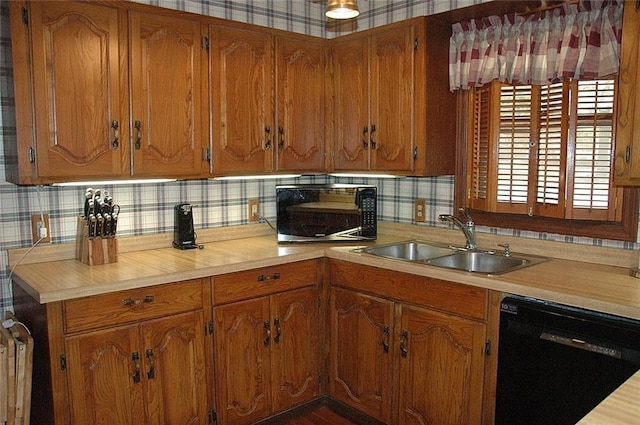 kitchen featuring radiator, decorative backsplash, sink, and black appliances