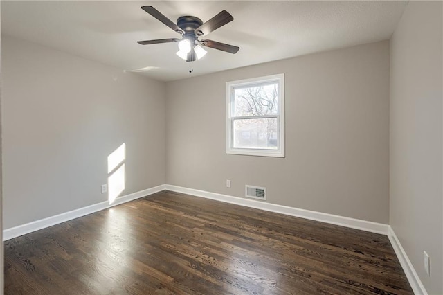 spare room featuring dark hardwood / wood-style flooring and ceiling fan