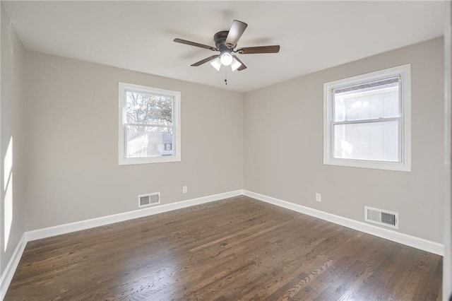 empty room with dark hardwood / wood-style floors and ceiling fan