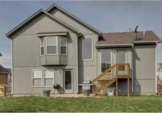 rear view of house with a lawn