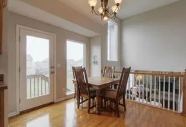 dining room featuring a notable chandelier and light hardwood / wood-style floors