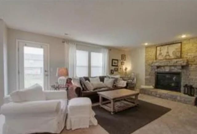 living room featuring a healthy amount of sunlight and a fireplace