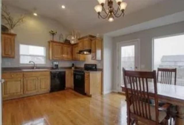 kitchen featuring sink, light hardwood / wood-style flooring, a chandelier, exhaust hood, and black dishwasher