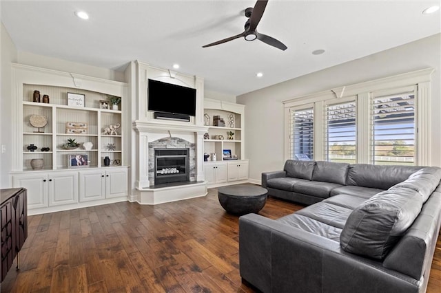 living room featuring ceiling fan and dark hardwood / wood-style flooring