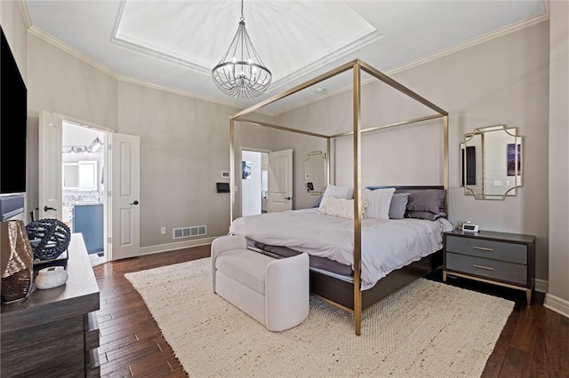 bedroom with ornamental molding, dark wood-type flooring, connected bathroom, and an inviting chandelier