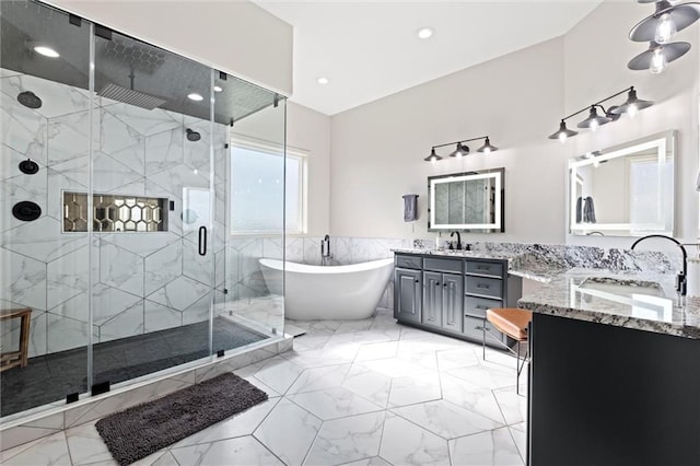 bathroom featuring shower with separate bathtub, vanity, and tile walls