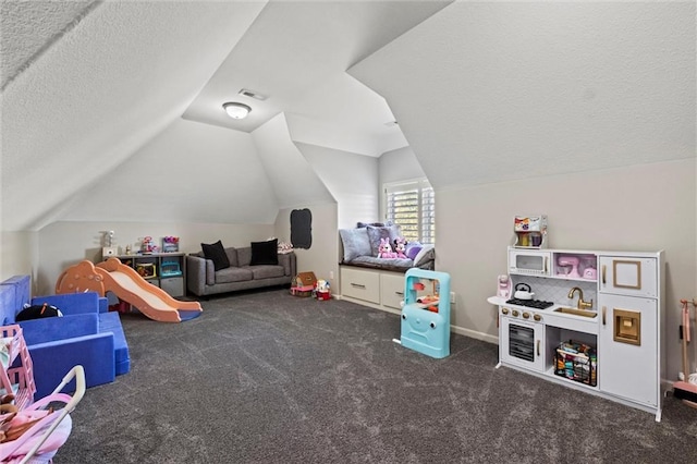 rec room with dark colored carpet, a textured ceiling, and lofted ceiling