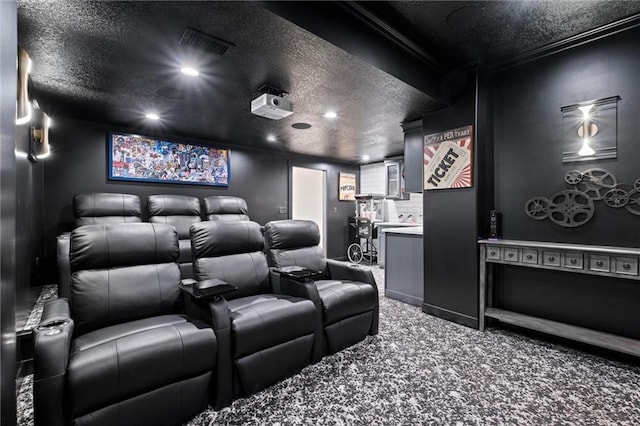 cinema with crown molding, carpet floors, and a textured ceiling