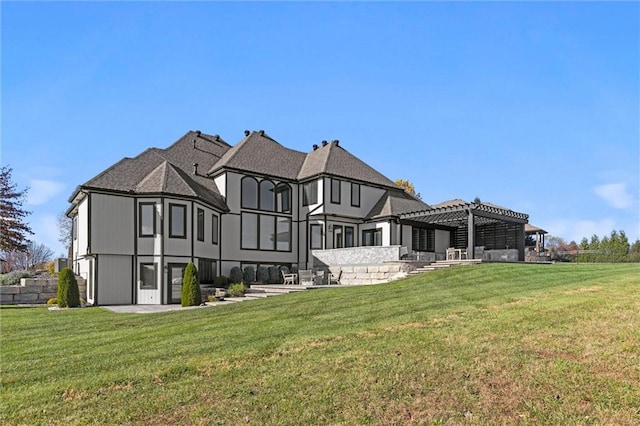 rear view of house featuring a pergola and a yard