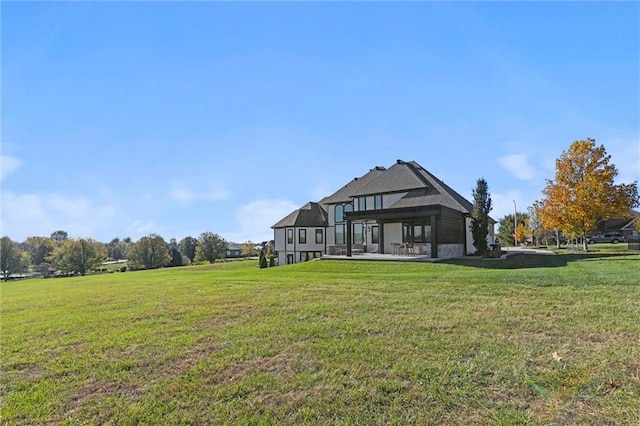 rear view of house with a yard