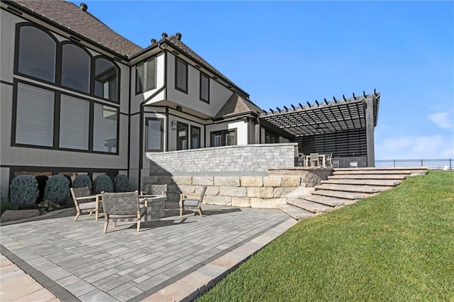 exterior space featuring a pergola, a patio area, and a lawn